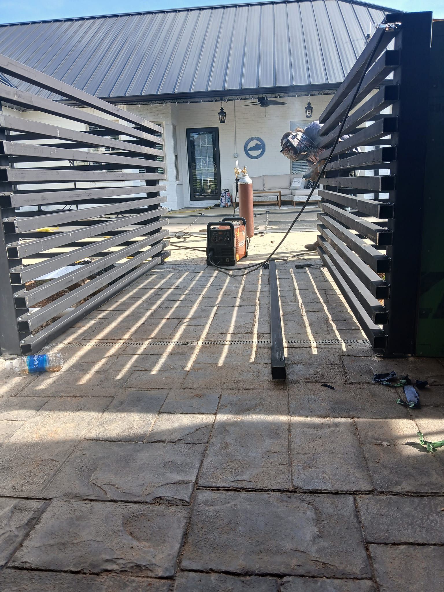 A person using a torch to cut through a metal sheet, creating sparks.