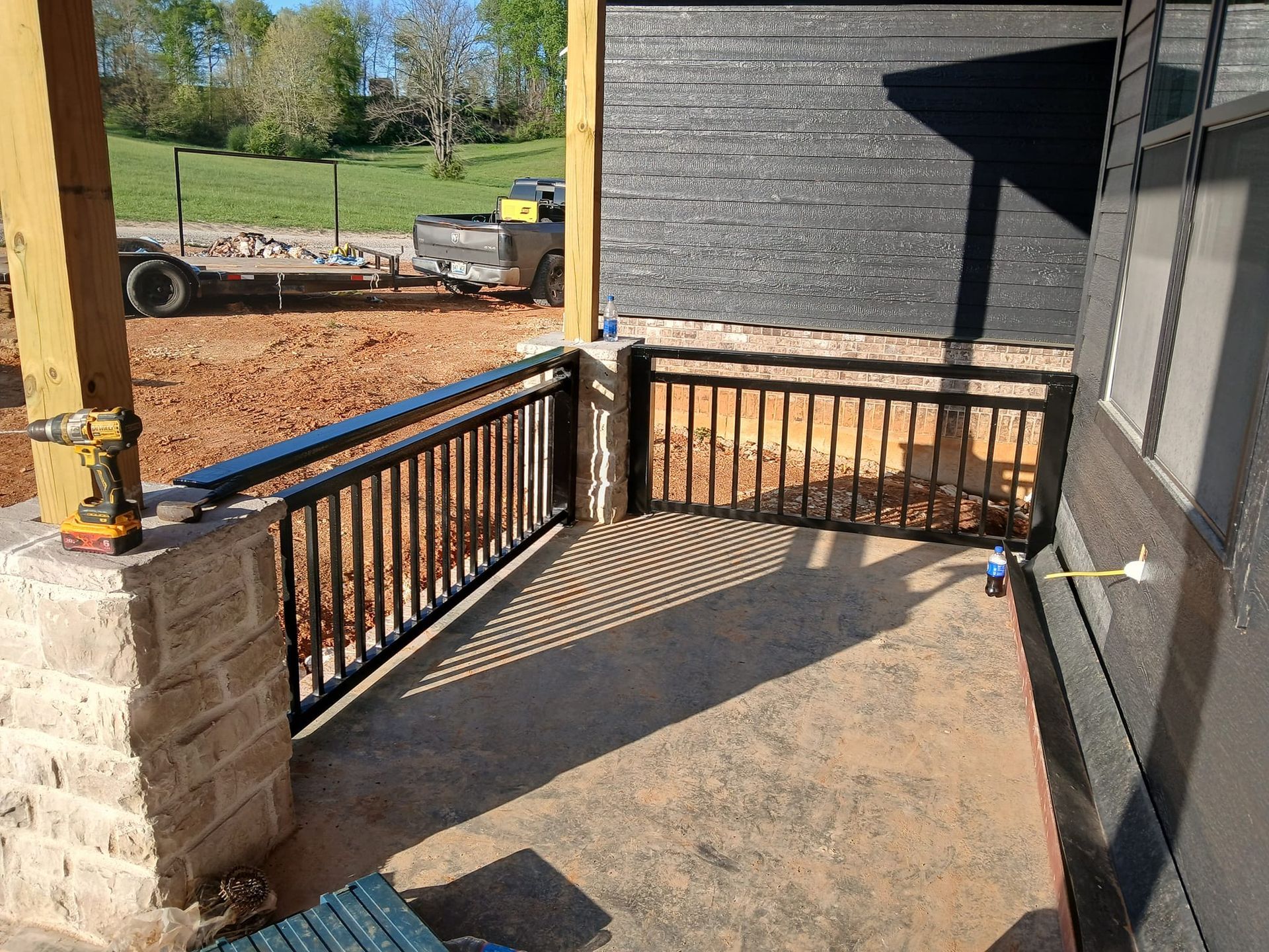 Laser cutter cutting metal, creating sparks. Blue and gray machine in a workshop.