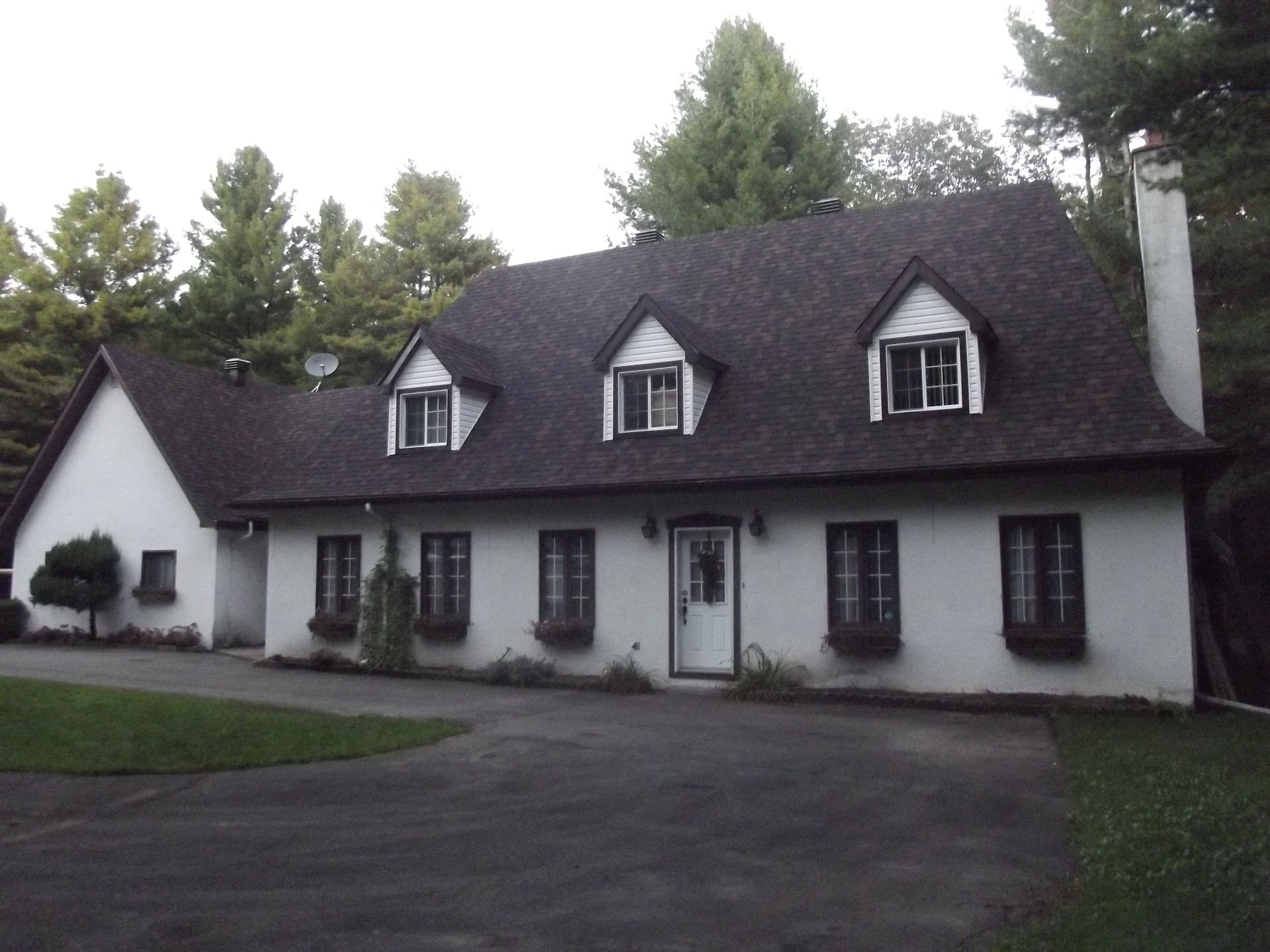 A large white house with a black roof