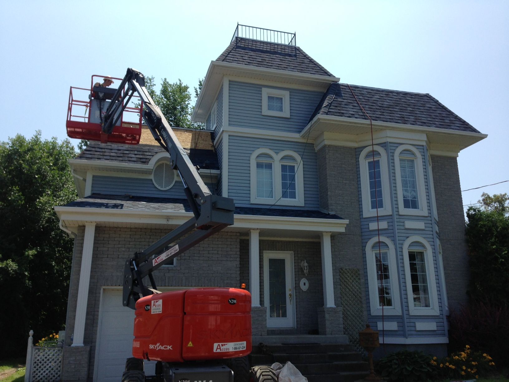 A large house with a crane on top of it