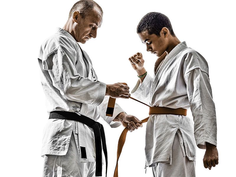 Two men in karate uniforms are standing next to each other.
