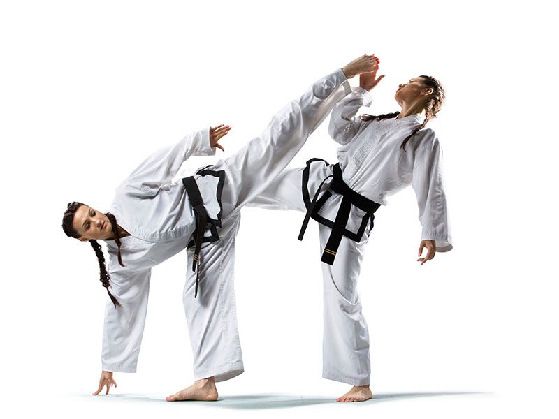 A man and a woman are practicing karate on a white background.
