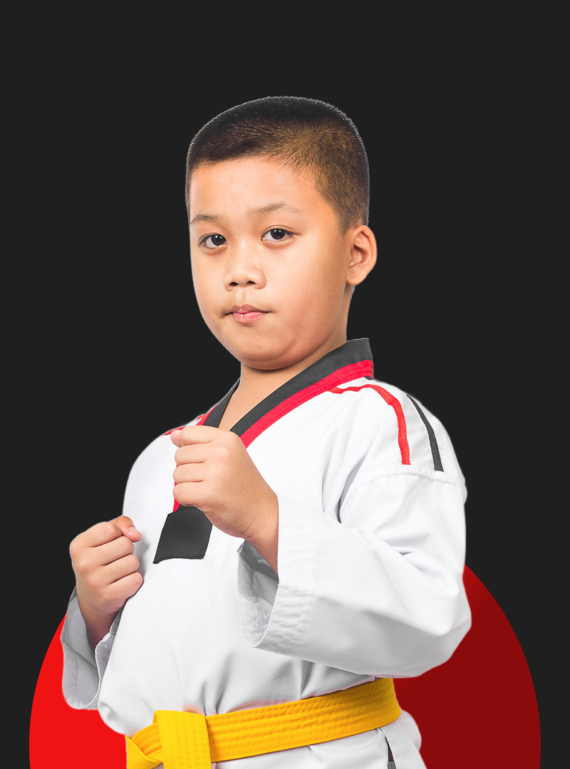 A young boy is wearing a karate uniform and a yellow belt.