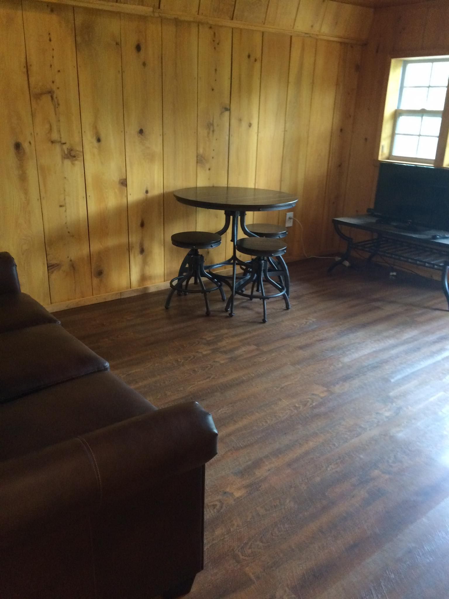 A living room with a table and chairs in it