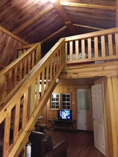 A living room with stairs leading up to the second floor