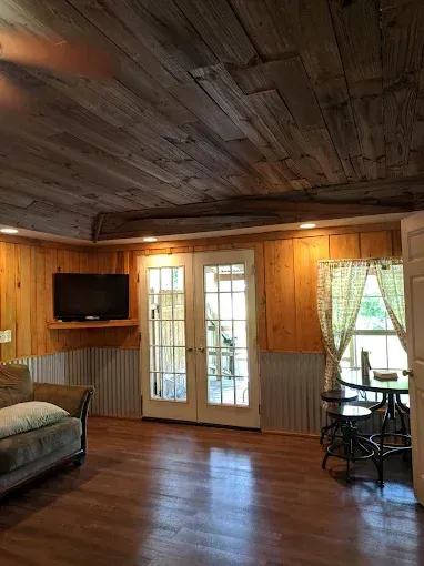 A living room with a couch , table , and television.