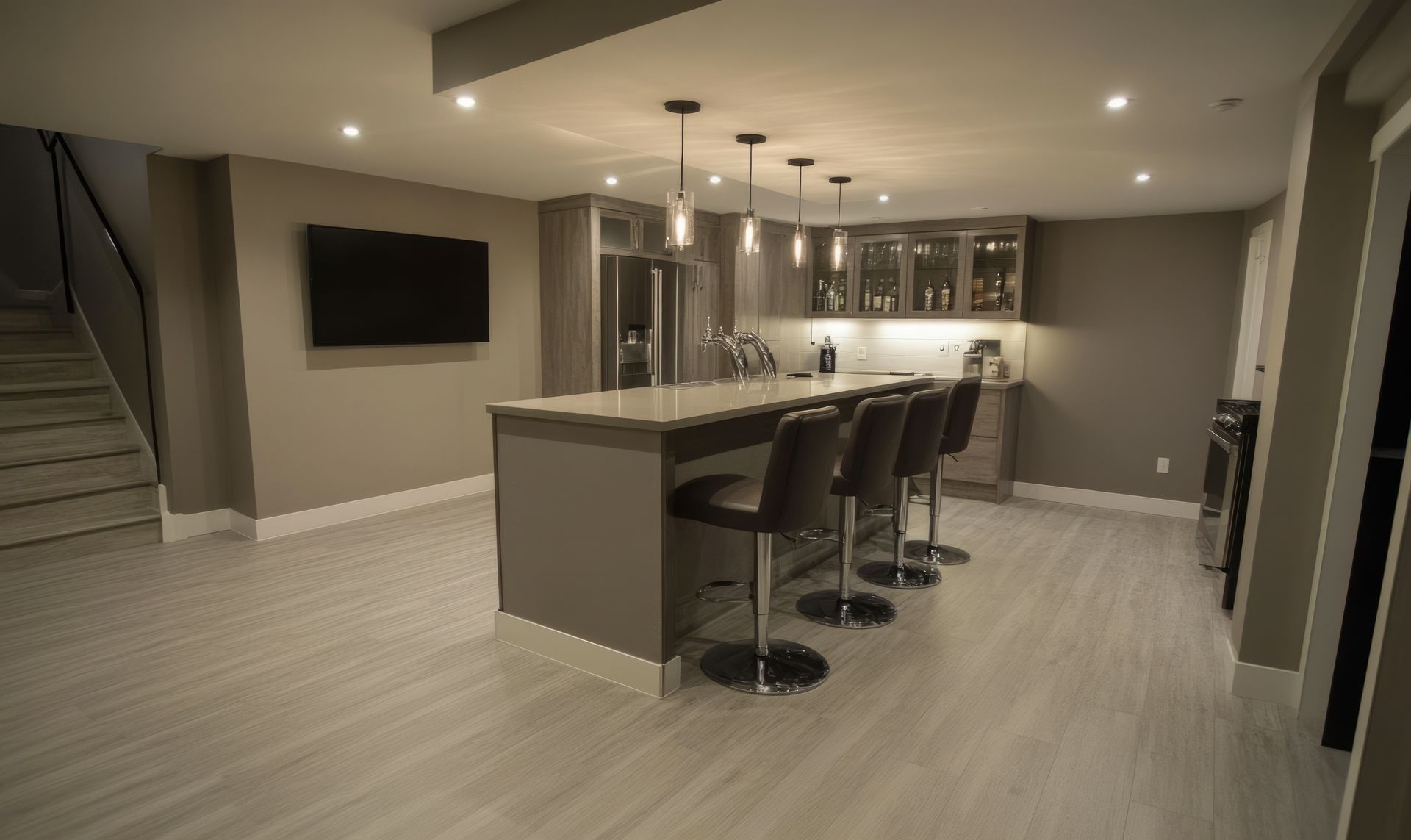 A kitchen with white cabinets and a large island in the middle.