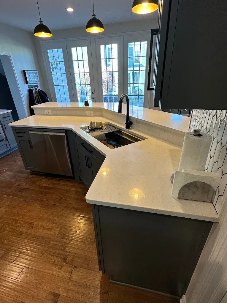 A kitchen with a sink , dishwasher , and stainless steel appliances.