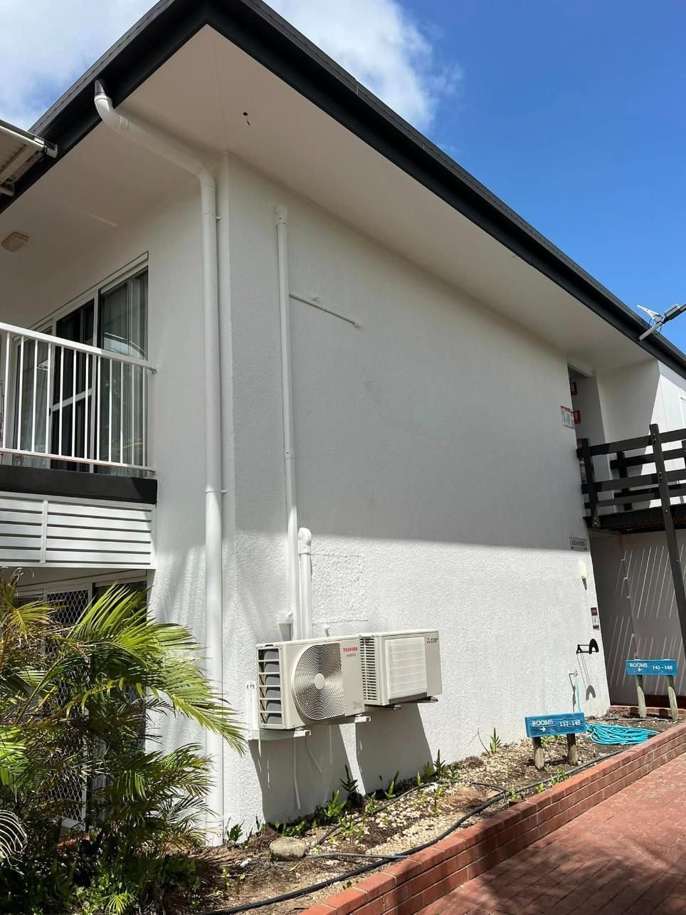 A White House with Black Windows and A Blue Sky in The Background — Darren Smith Painting Pty Ltd in Mirani, QLD