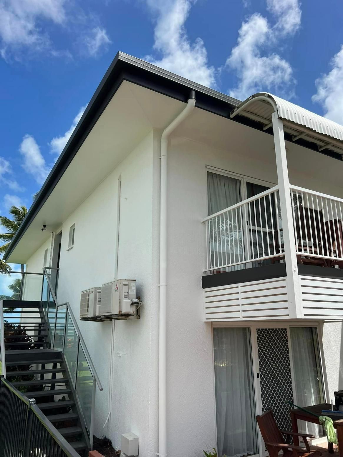 A White House with A Balcony and Stairs Leading up To It — Darren Smith Painting Pty Ltd in Sarina, QLD