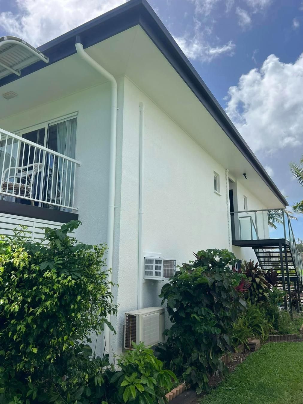 A White House with A Balcony and Stairs in The Backyard — Darren Smith Painting Pty Ltd in Mackay, QLD