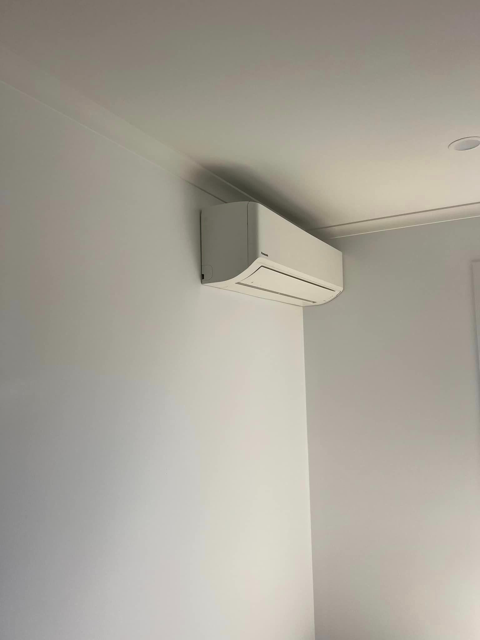 A White Air Conditioner Is Hanging from The Ceiling in A Room — Darren Smith Painting Pty Ltd in Mackay, QLD