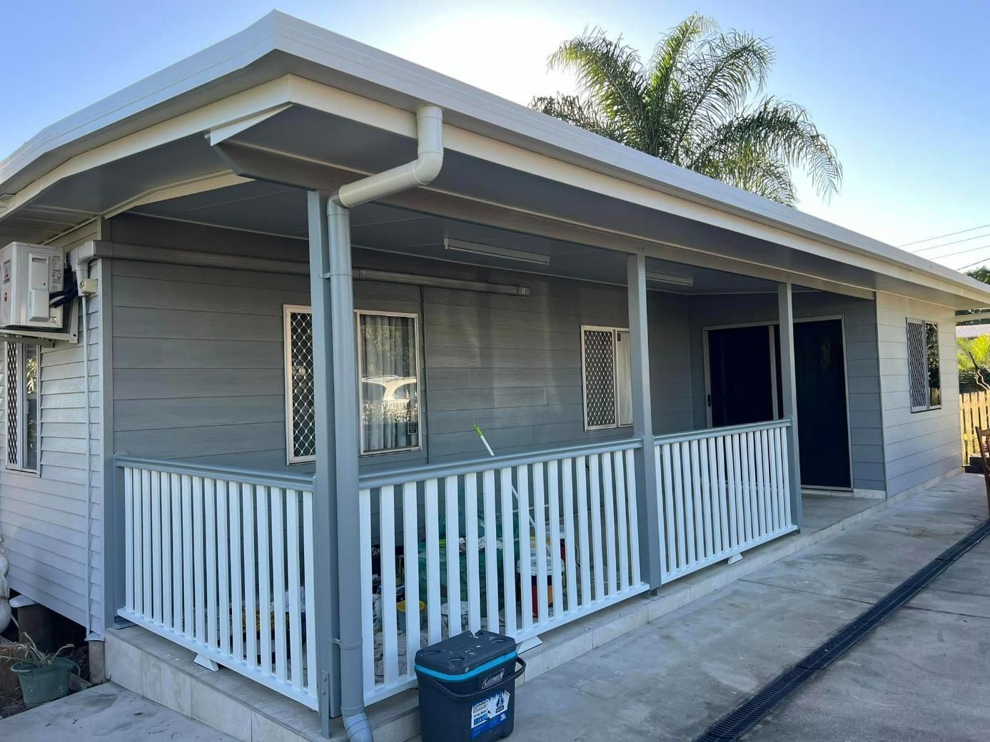 A Small House with A Porch and A Cooler on The Side of It — Darren Smith Painting Pty Ltd in Rural View, QLD