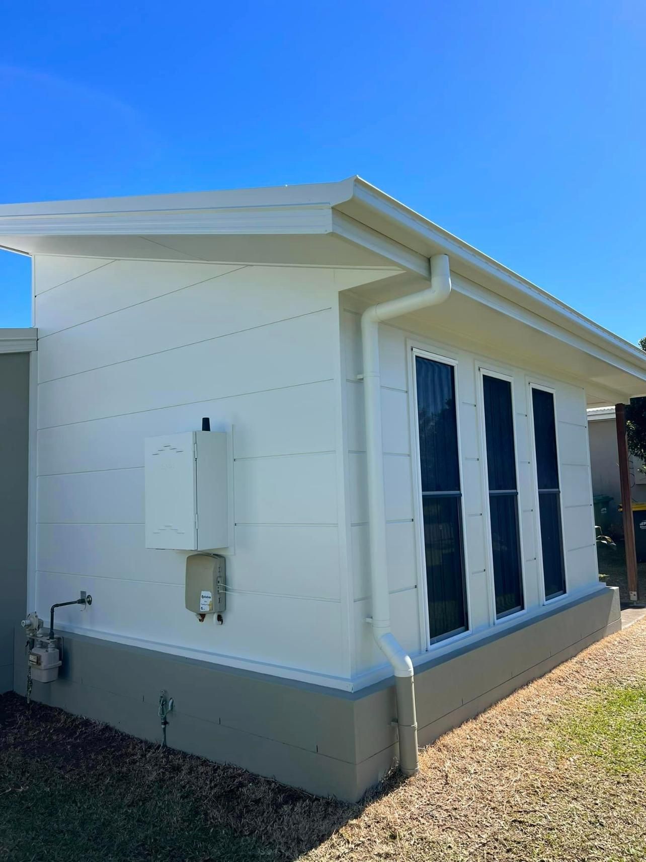 A White House with A Blue Sky in The Background — Darren Smith Painting Pty Ltd in Northern Beaches, NSW