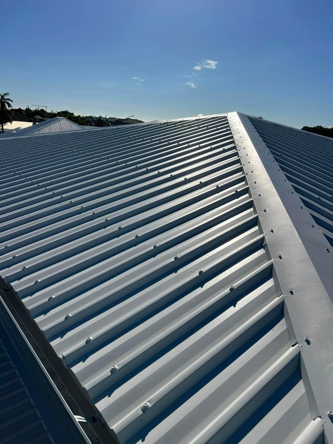 A Close up Of a Roof with A Blue Sky in The Background — Darren Smith Painting Pty Ltd in Mackay, QLD