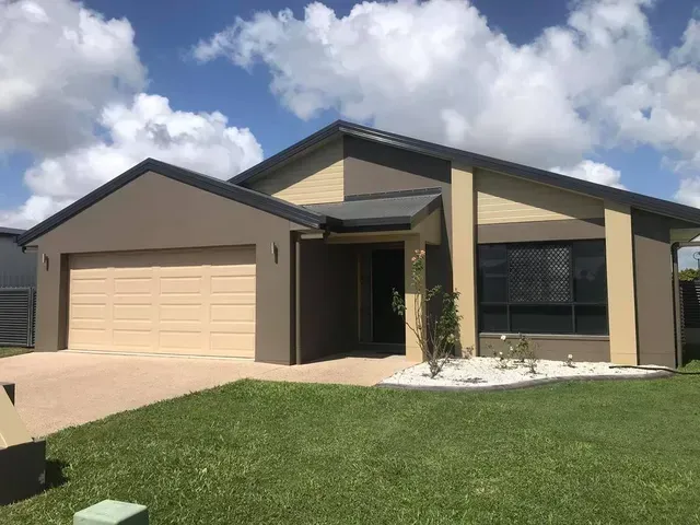 A House with Two Garage Doors and A Large Lawn in Front of It — Darren Smith Painting Pty Ltd in Rural View, QLD