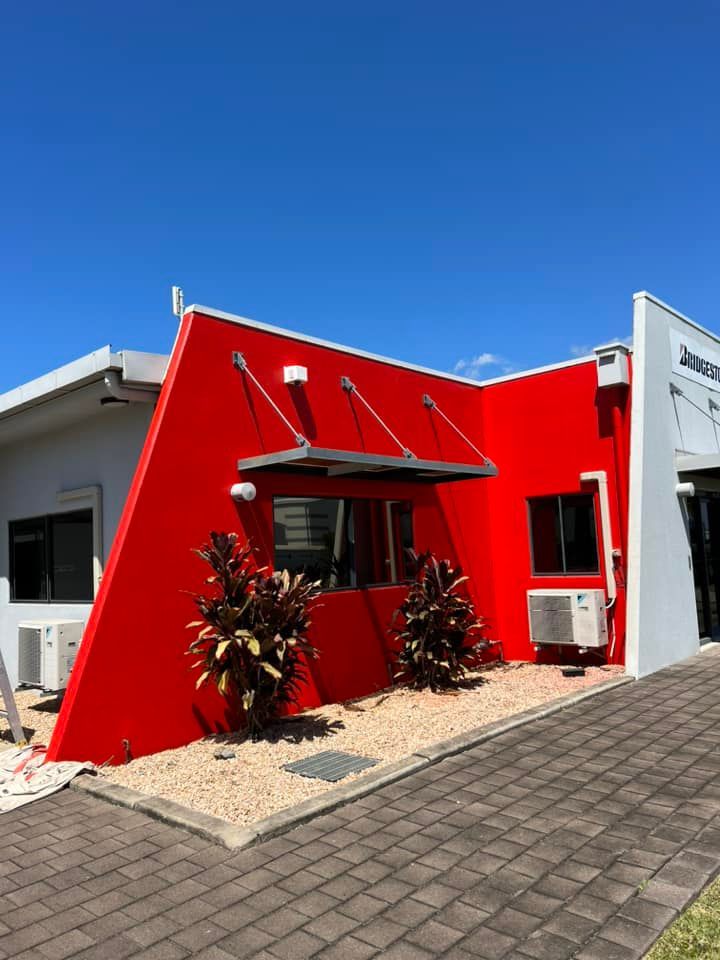 A red and white building with a blue sky in the background