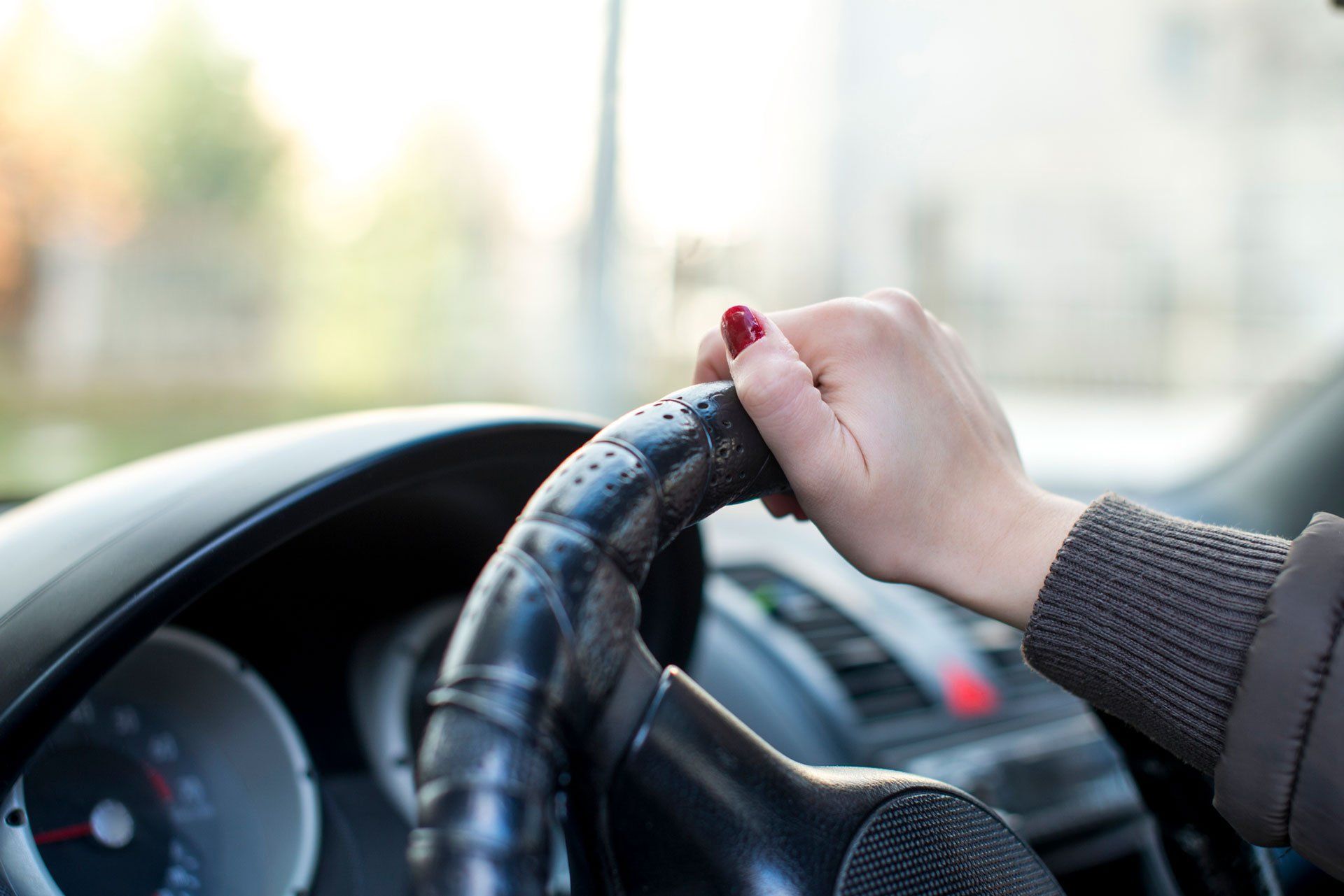 Woman Holding A Steering Wheel — Virginia Beach, VA — AAPEX Driving School