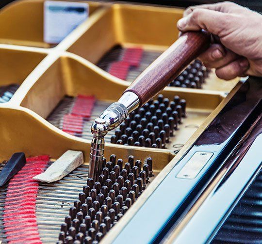 Person Tuning the Piano — Lancaster, PA — Dawn Herring's Piano Service Person Tuning the Piano — Lancaster, PA — Dawn Herring's Piano Service