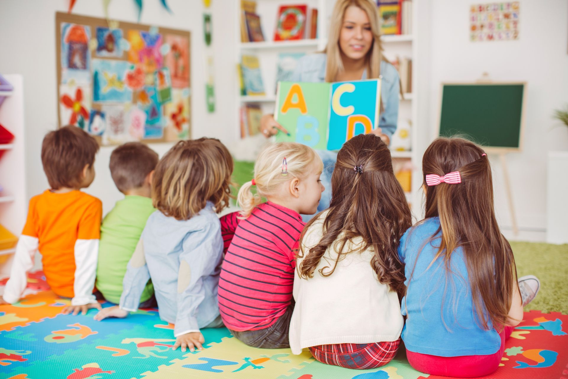 Teacher leading letter activity with children, showcasing excellent child day care services. Teacher leading letter activity with children, showcasing excellent child day care services.