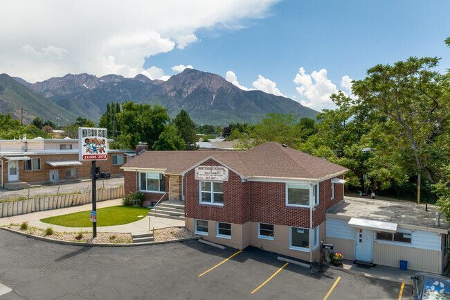 An aerial view of a building with mountains in the background