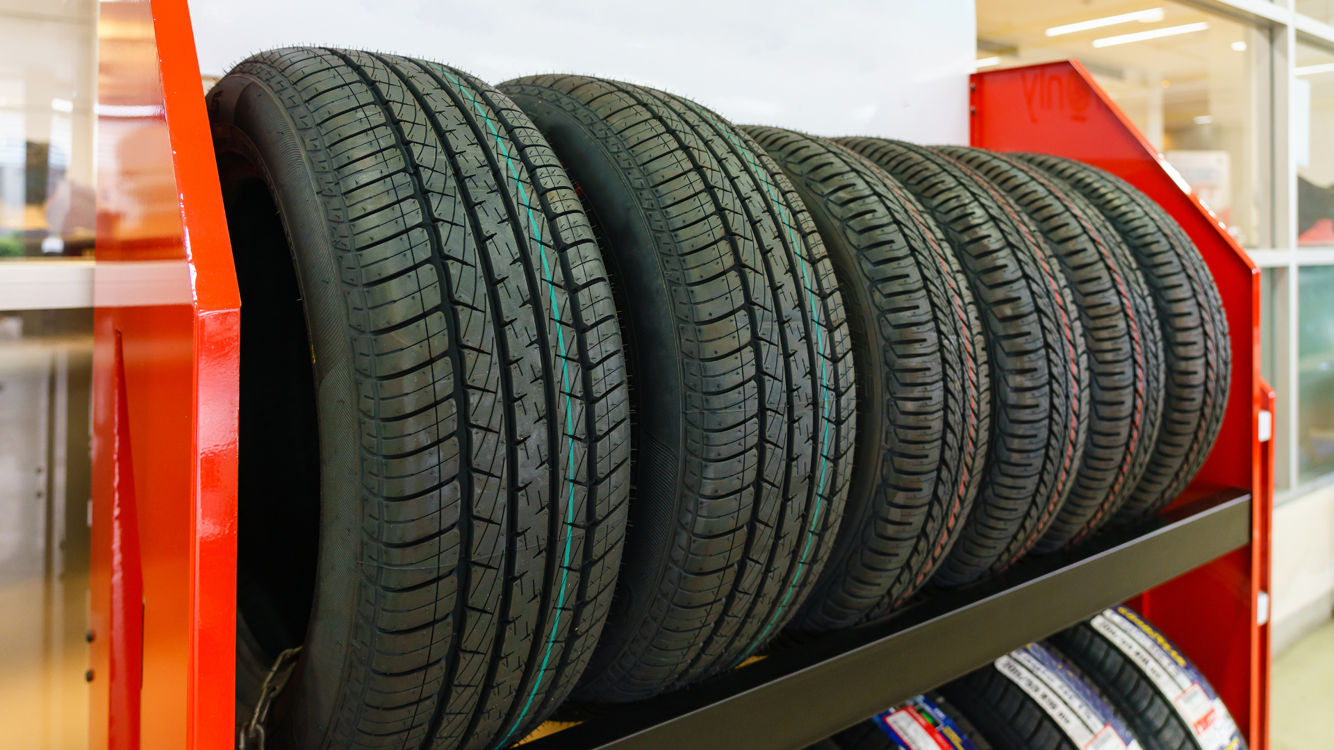 A stack of tires sitting on top of each other on a shelf.