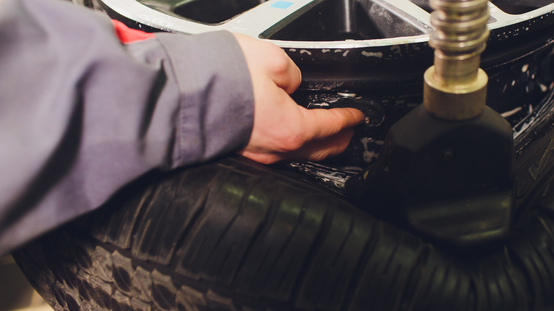 A person is inflating a tire with a vacuum pump.