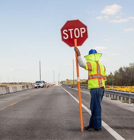 Traffic Controller Holding Stop Sign on Road — Traffic Control in Toowoomba, QLD