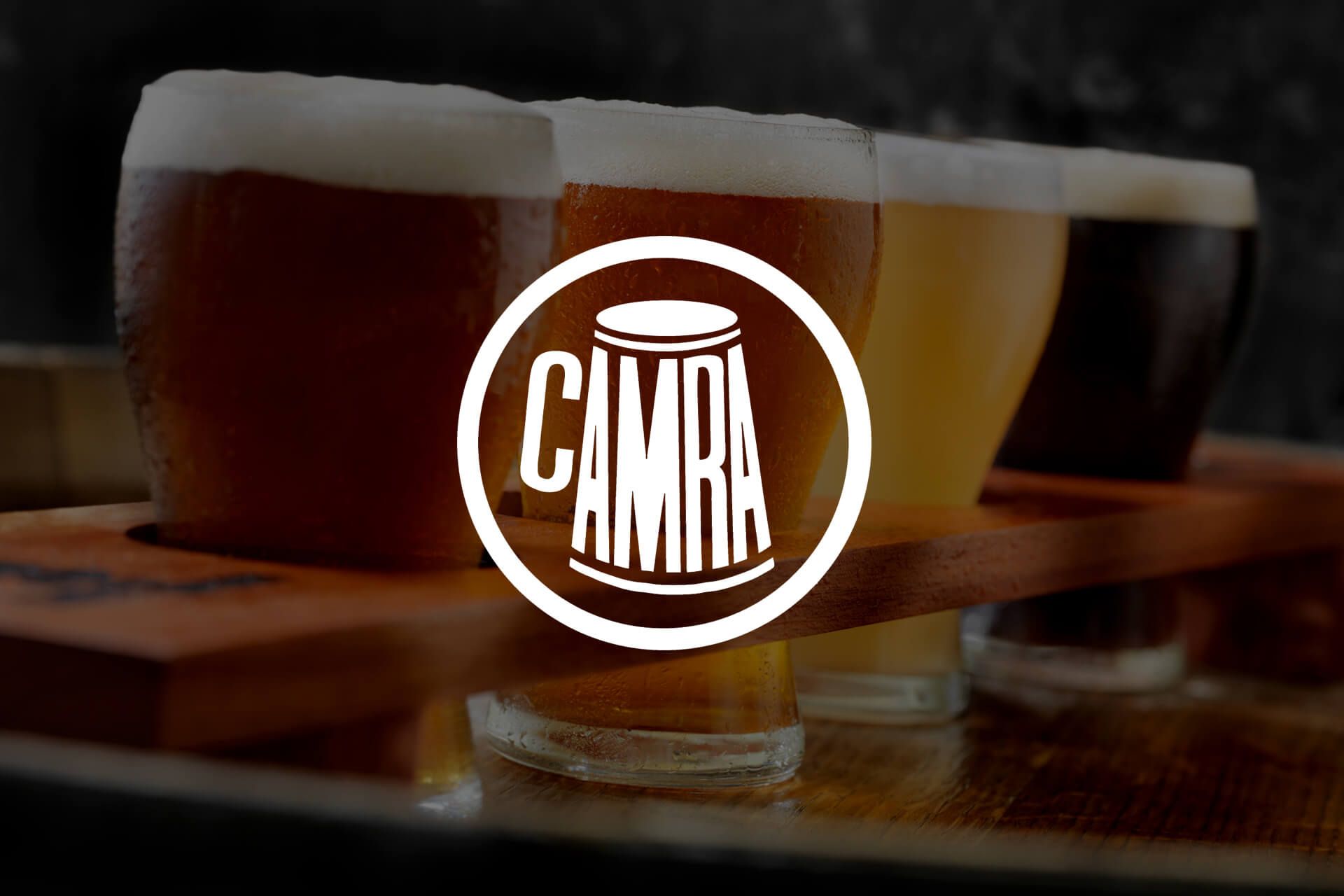 a tray of beer glasses with the camra logo on it