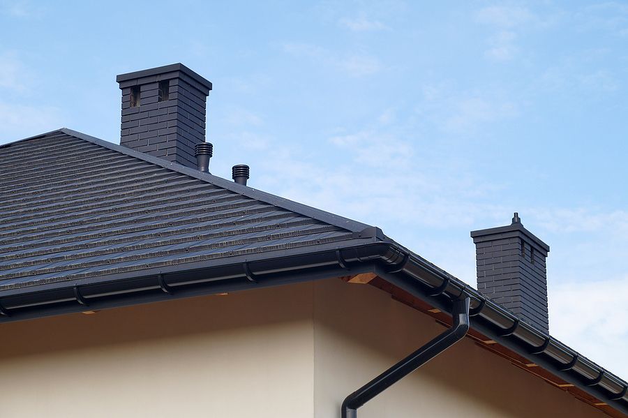 The roof of a house with chimneys on it