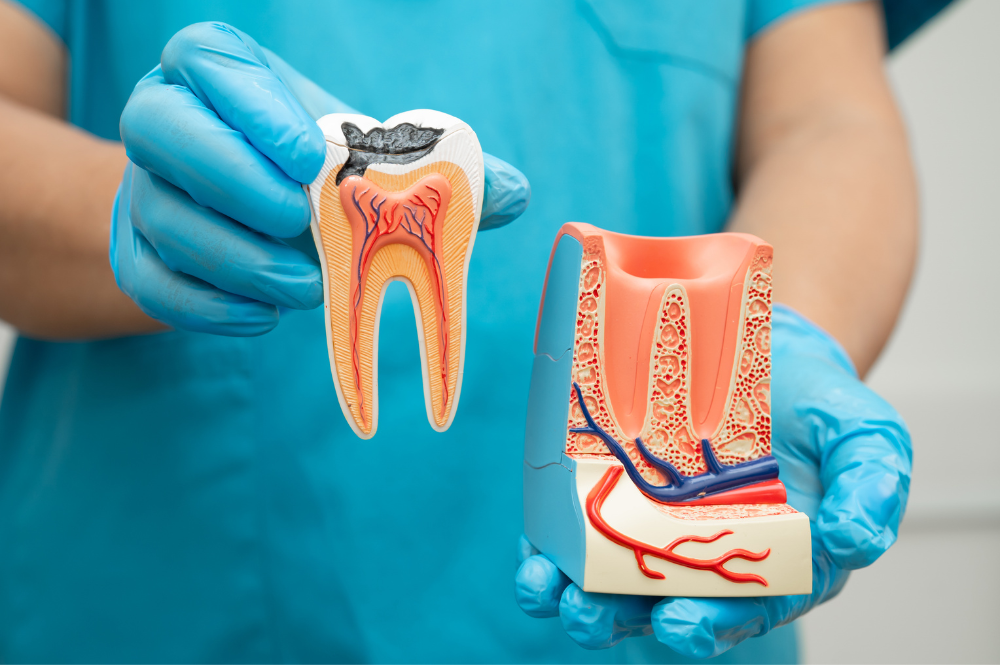 Woman demonstrating areas for cosmetic injections: frown lines, crow's feet, jawline.