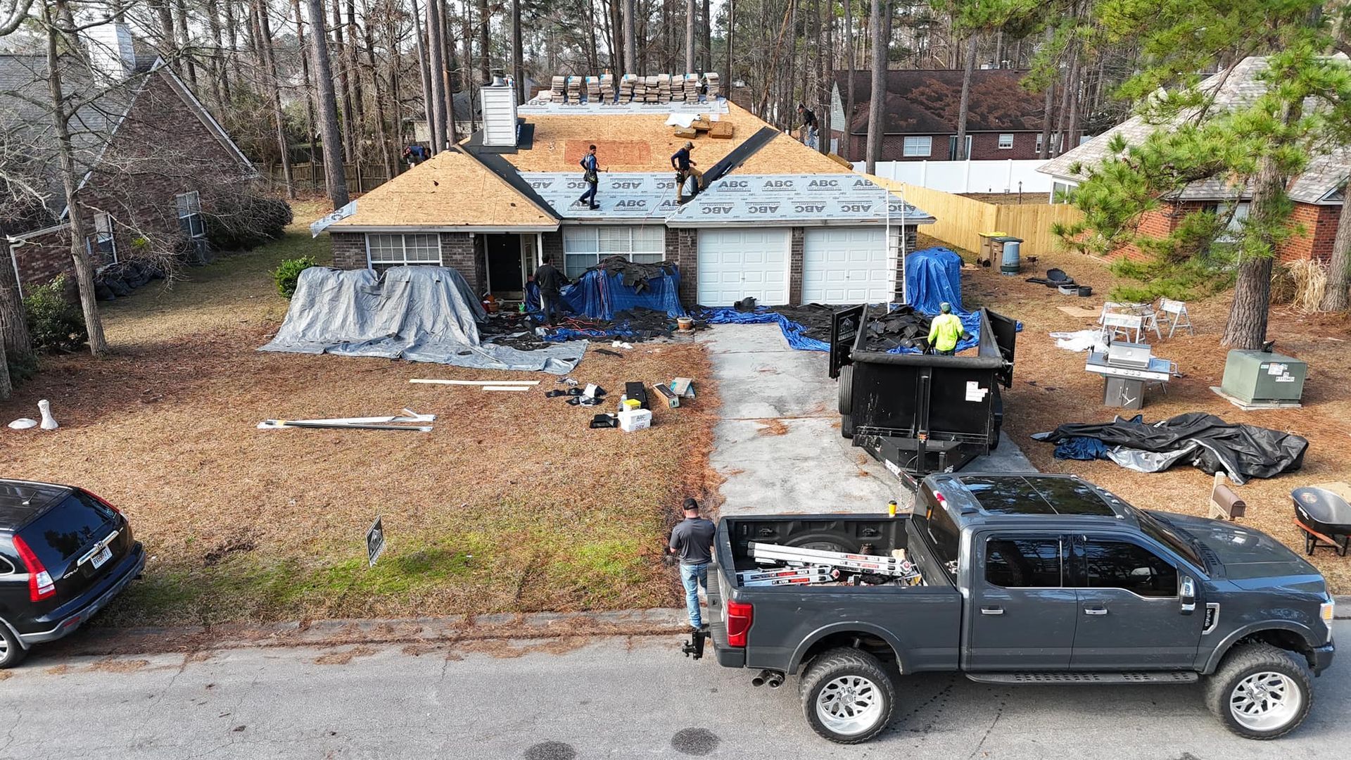 An aerial view of a house under construction with a truck parked in front of it.