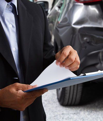 Insurance Agent Examining Black Car after Accident — Meriden, CT — Thompson, O’Connor & Associates, LLC