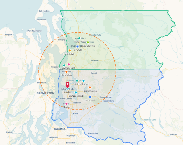 Map with green and blue outlined regions, a red location pin, and a dashed orange radius circle.