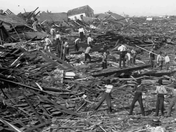 A group of people are standing in a pile of rubble.