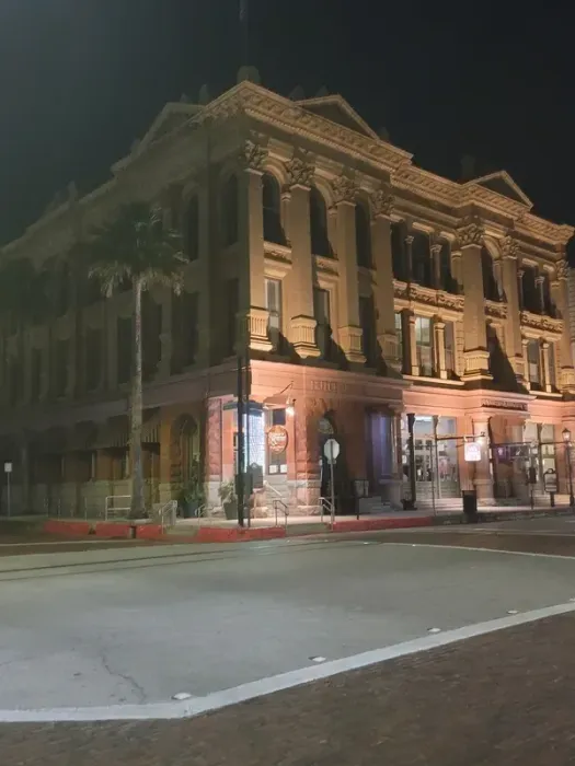 A large brick building is lit up at night