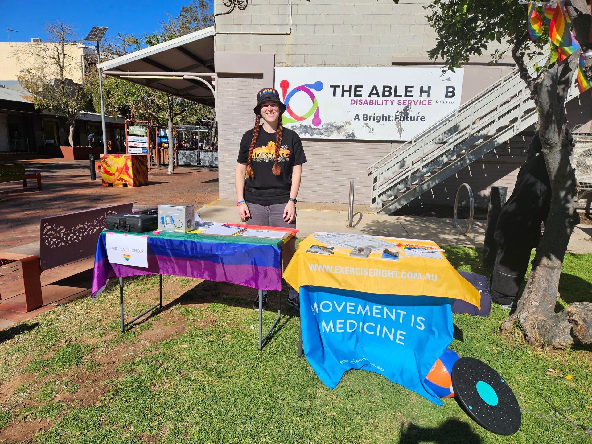 A man is standing in front of a table with a sign that says movement is medicine.