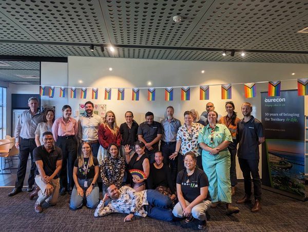 A group of people are posing for a picture in a room.