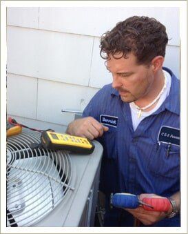 Man Repairing a air con machine — AC Repair in Independence, MO