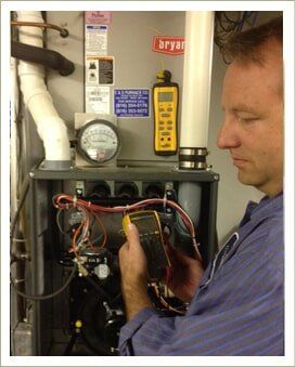 Man working on the wiring of a machine — AC Repair in Independence, MO