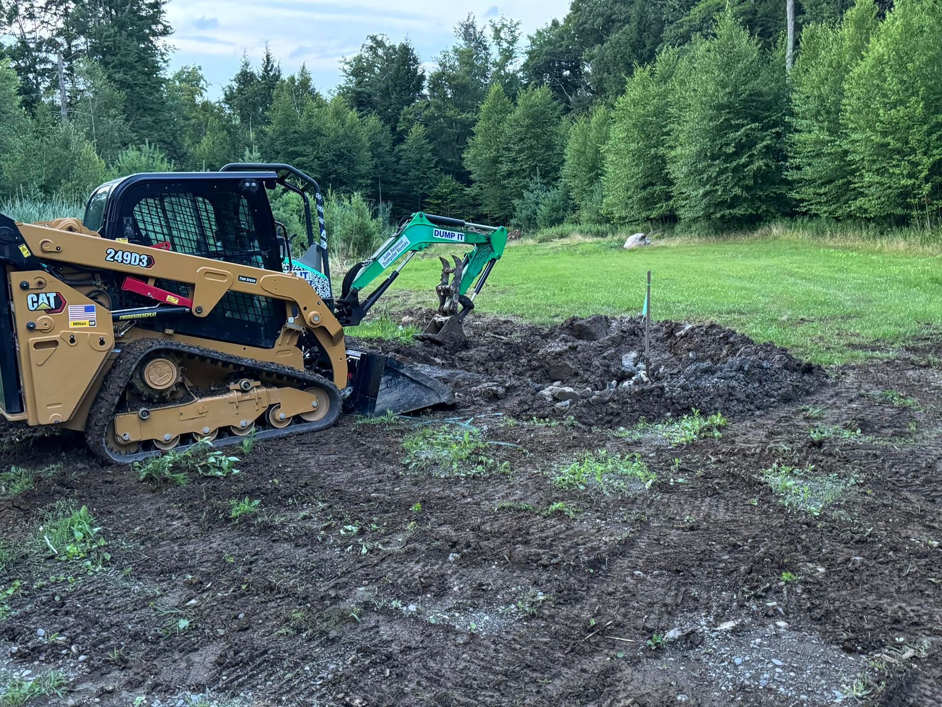 A bulldozer is digging a hole in the dirt in a field.
