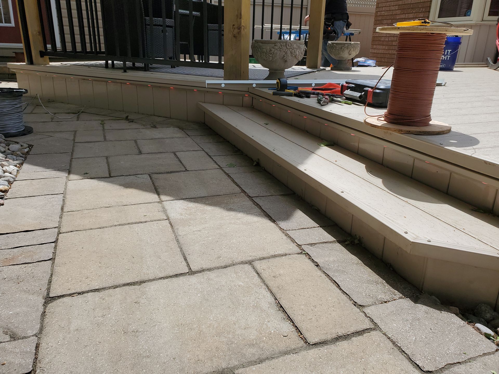 A brick walkway with stairs leading up to a balcony