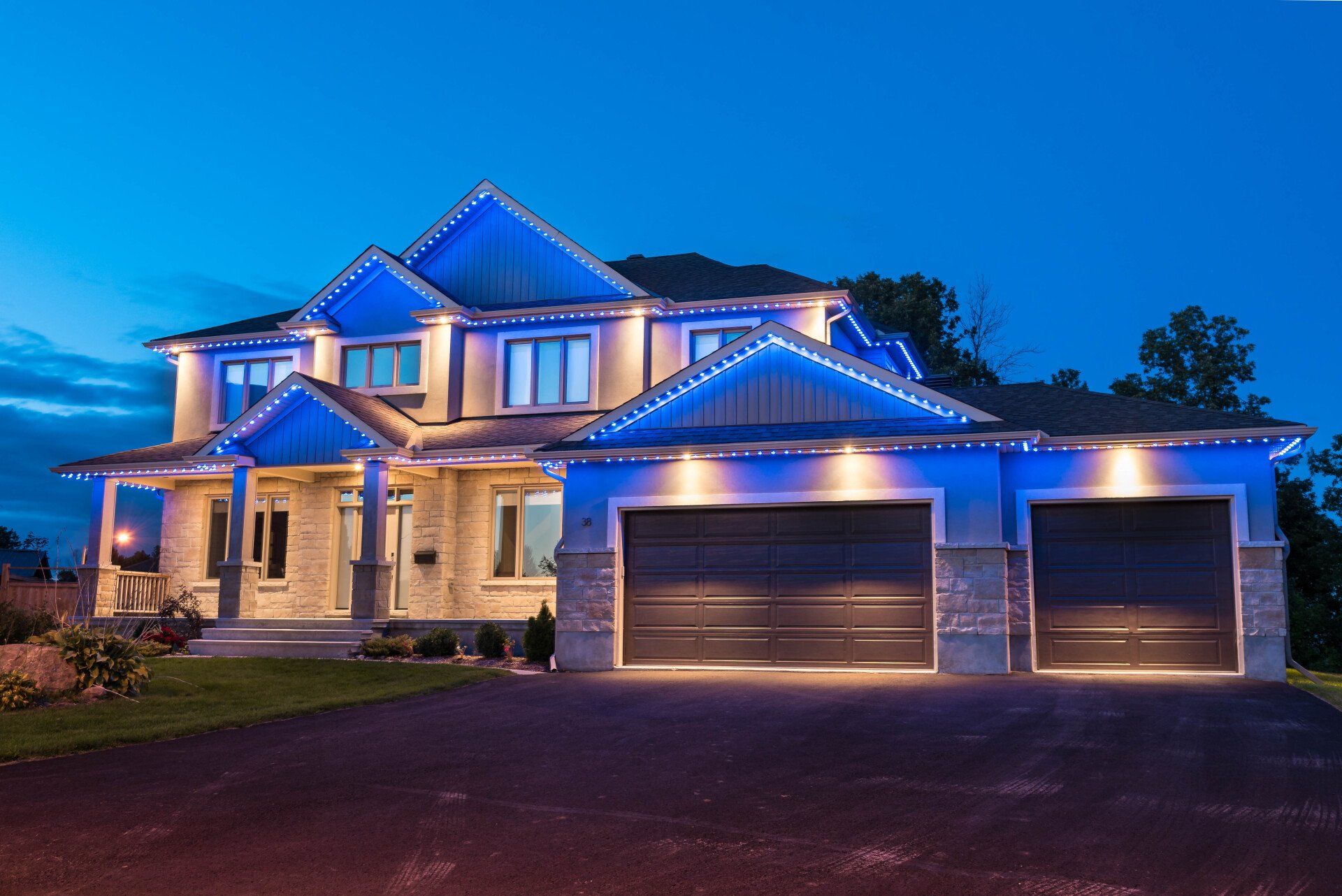 A large house with blue lights on it at night