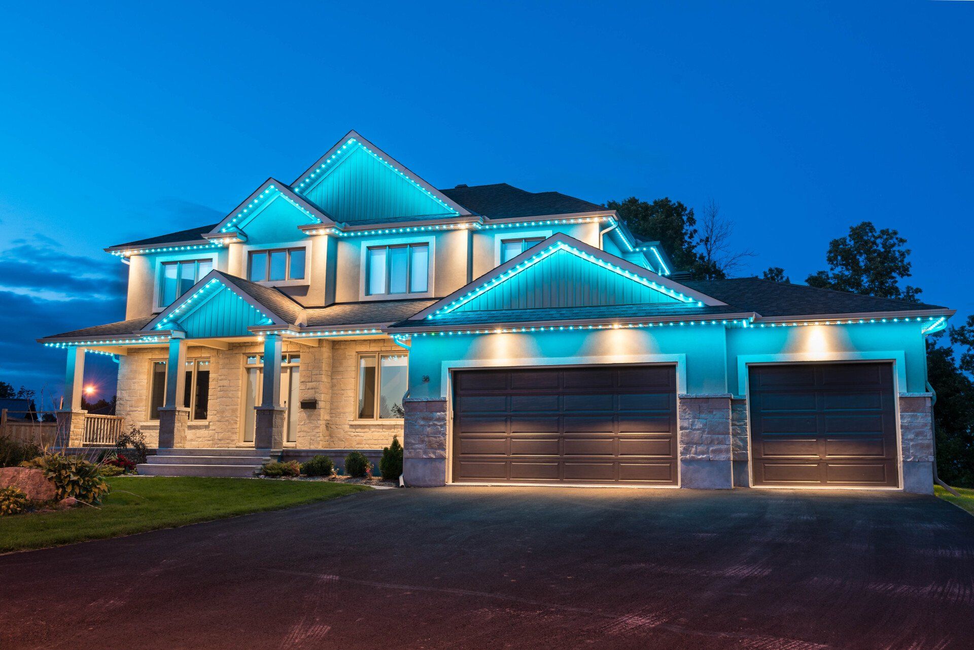 A large house with blue lights on it at night