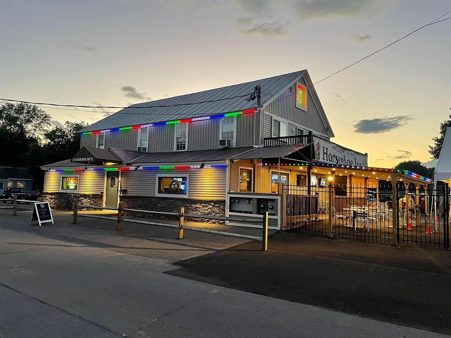 A large building with a lot of windows is lit up at night.