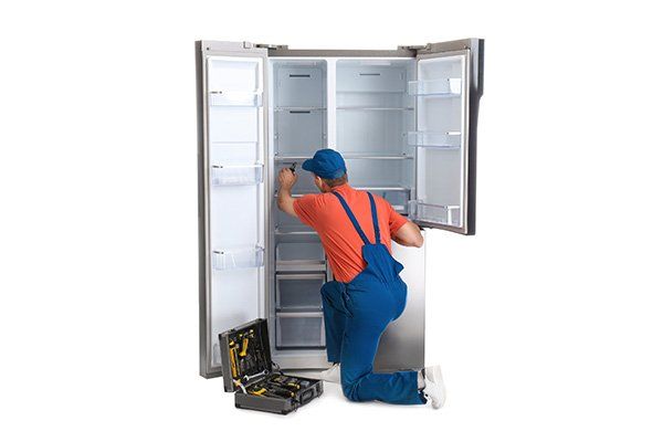 Male Technician Repairing Refrigerator — Seal Tite in Tweed Heads South, NSW