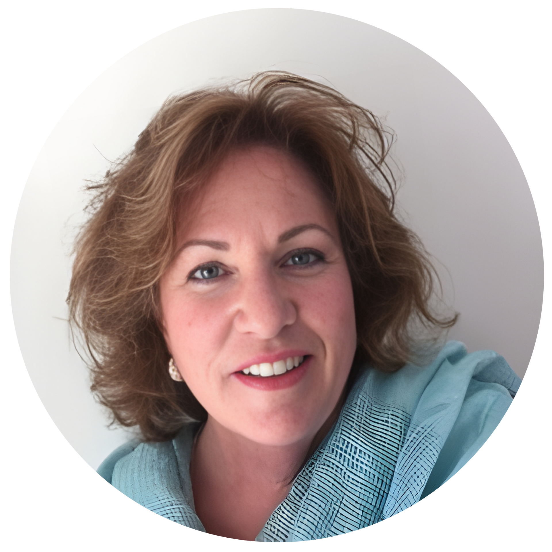 Woman with curly auburn hair smiles, wearing a turquoise scarf.