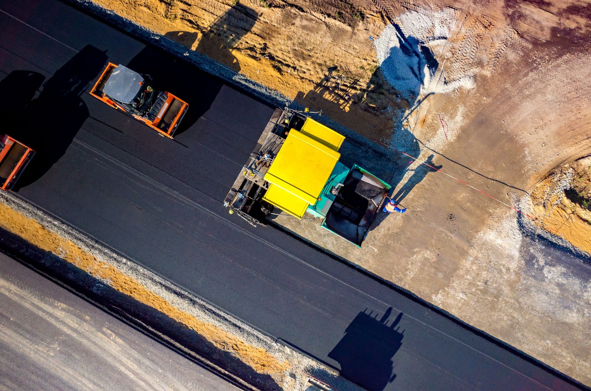 An aerial view of a truck driving down a road.