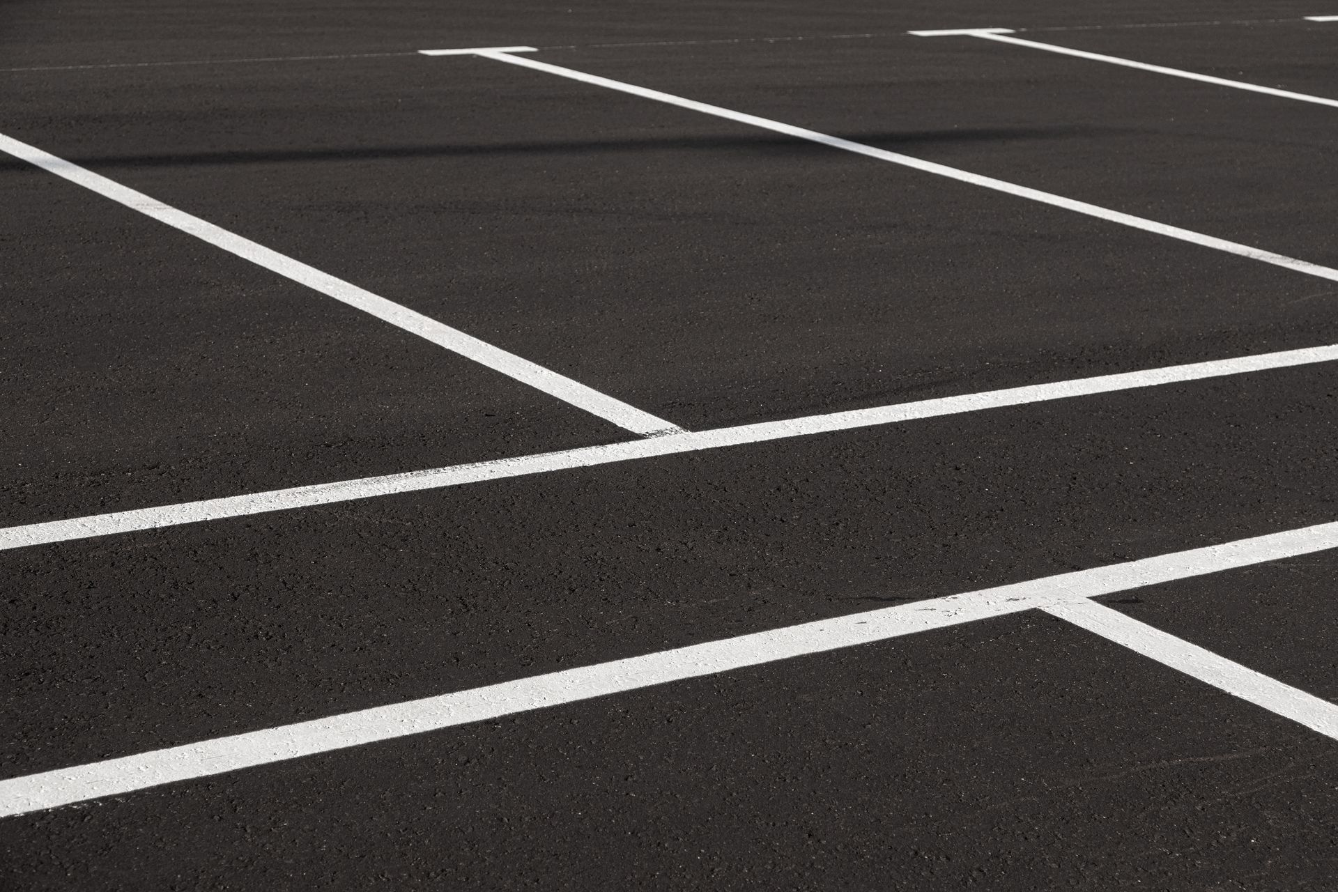 A parking lot with white lines on the asphalt