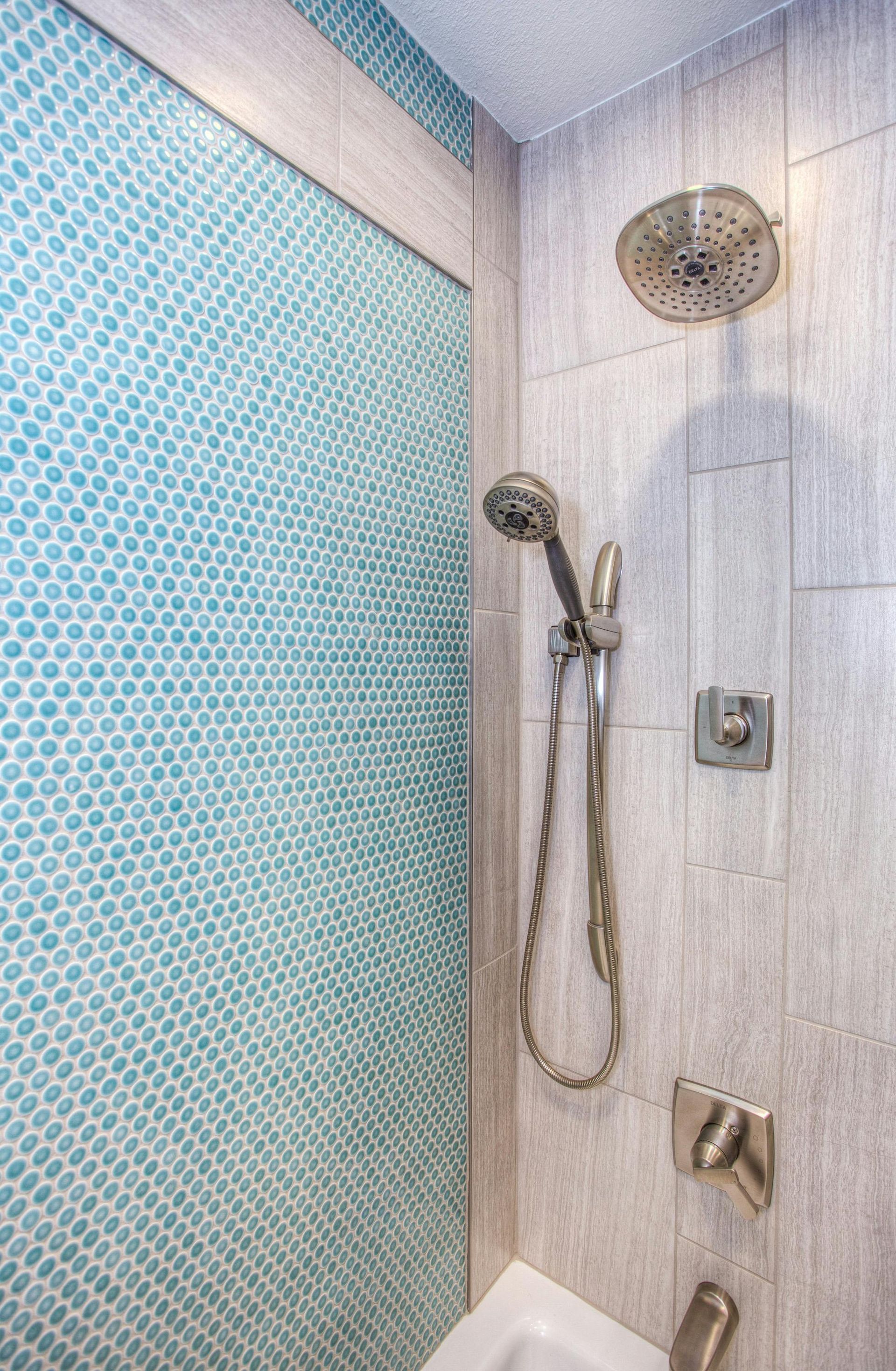 A creatively tiled bathroom with circular light blue geometric tiles